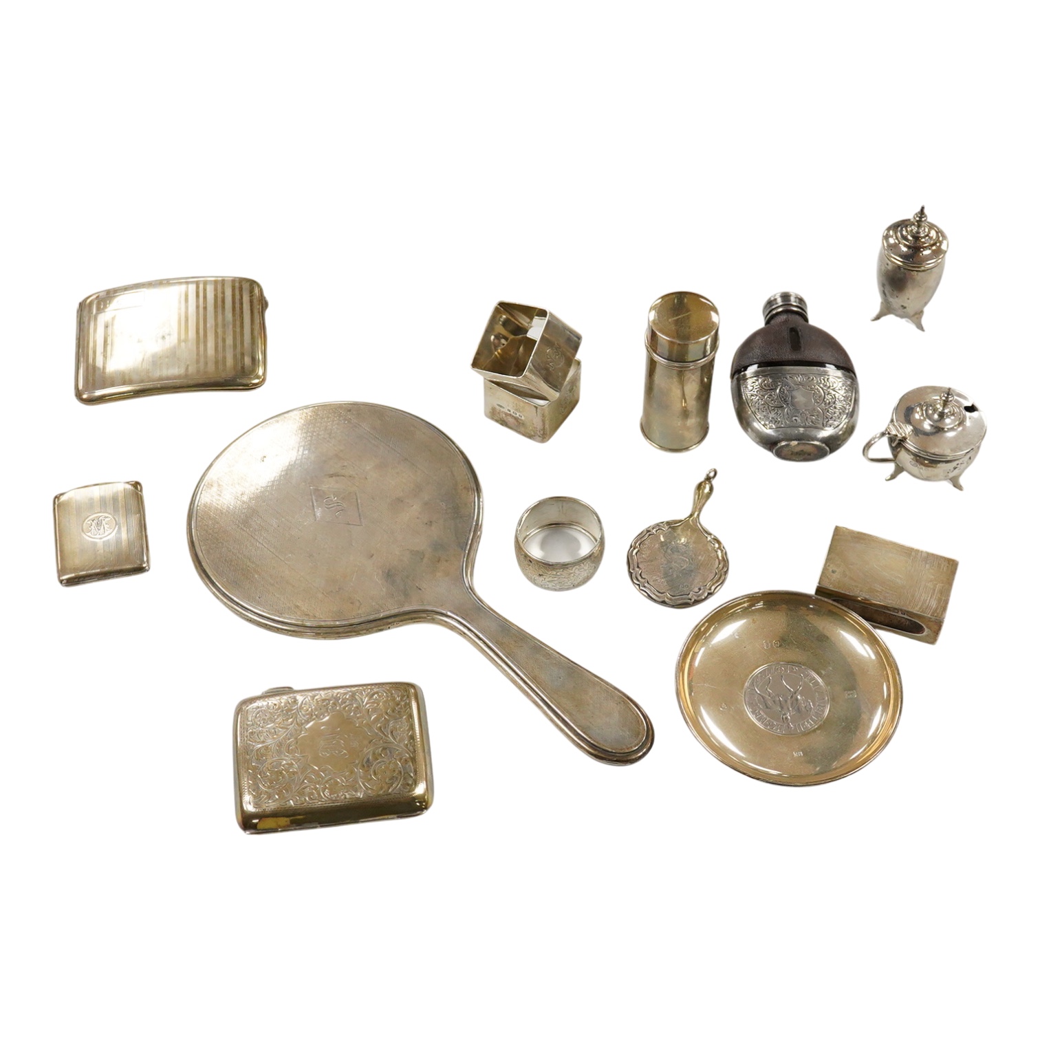 Sundry small silver, including two cigarette cases, a match sleeve holder, three napkin rings, two condiments, matchbox sleeve, shaving brush canister, commemorative small dish, a mounted hand mirror and mounted handbag